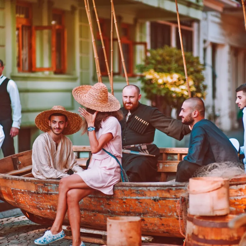 group of people sitting on boat on road